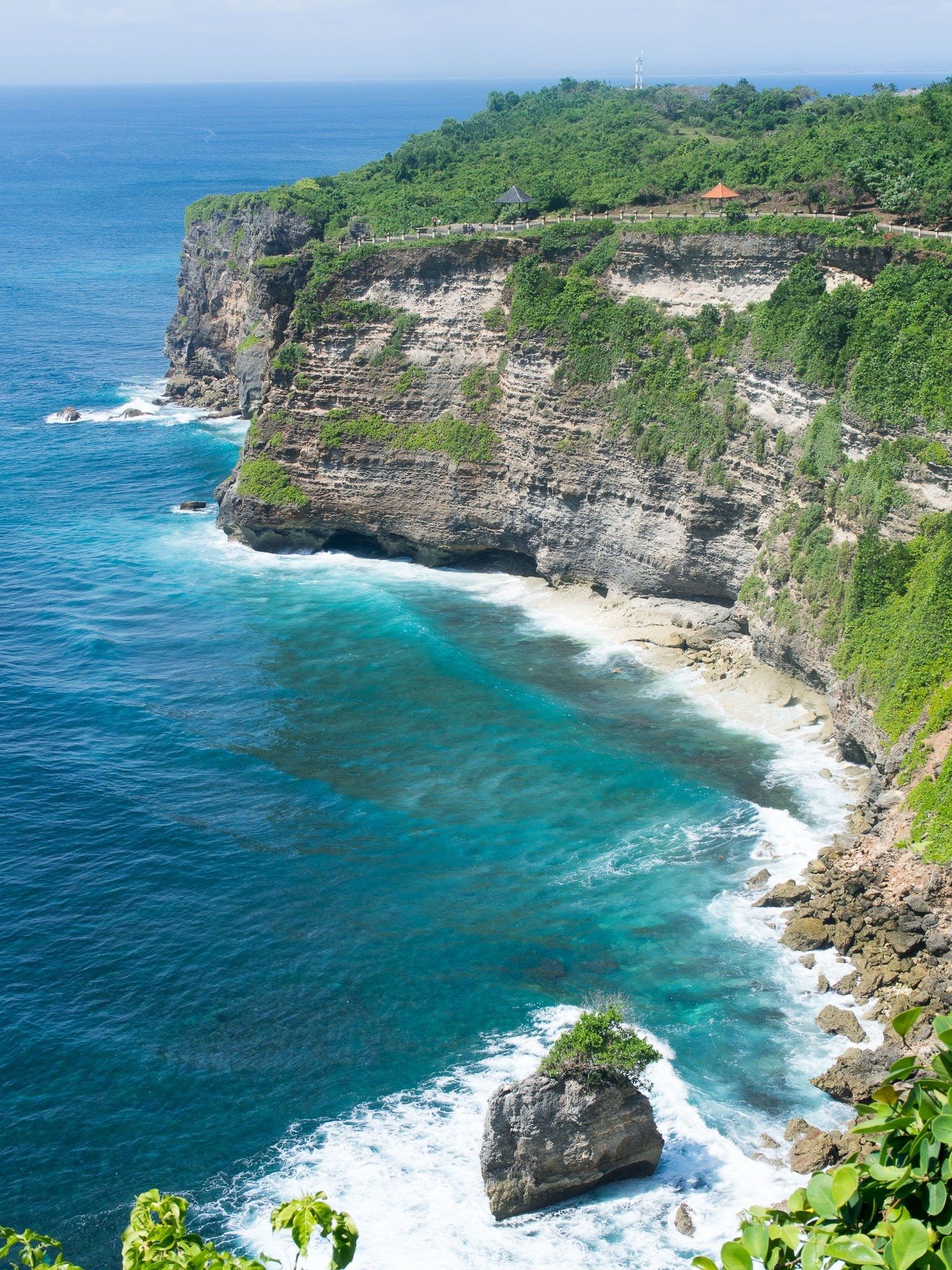 The limestone cliffs and turquoise water of the Uluwatu coast.