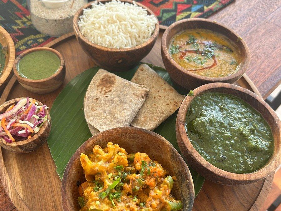 An Indian thali at Bazaar — curries, rice and naan on a banana leaf.