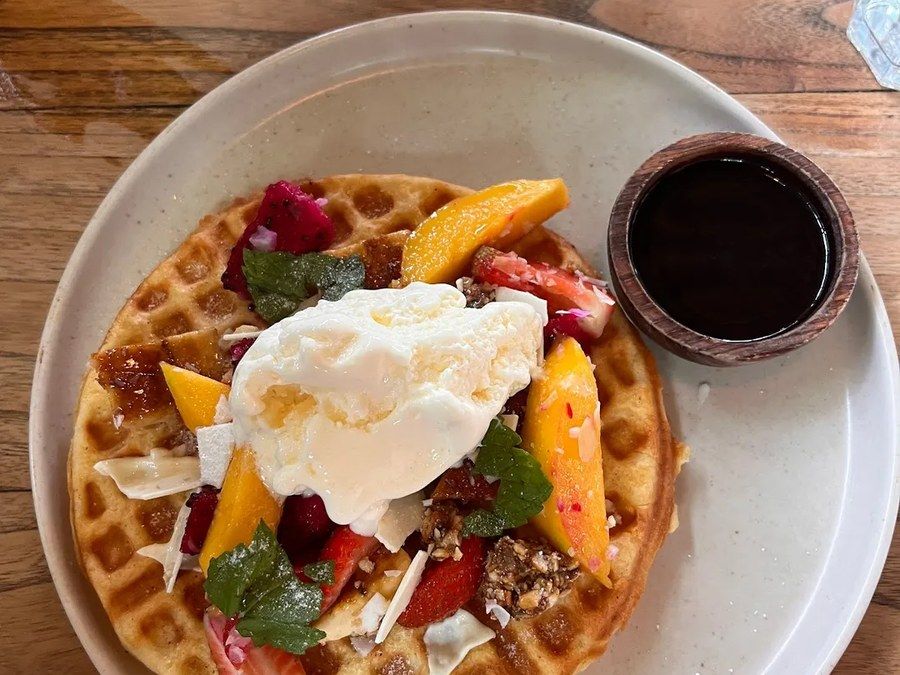 A brunch plate of waffles and fruit at Nourish.
