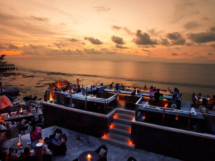 The clifftop Rock Bar at Ayana as the sun goes down over the sea.